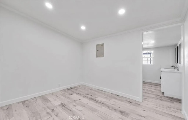 11912 Arthur Dr, Anaheim, CA 92804 - unfurnished room with crown molding, light wood-style flooring, recessed lighting, and electric panel
