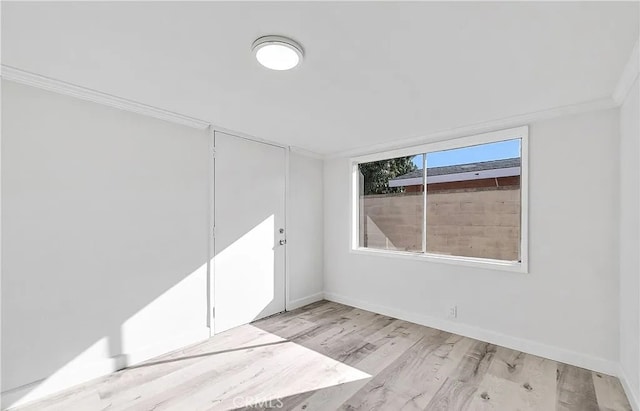 11912 Arthur Dr, Anaheim, CA 92804 - empty room with light wood-style flooring and ornamental molding