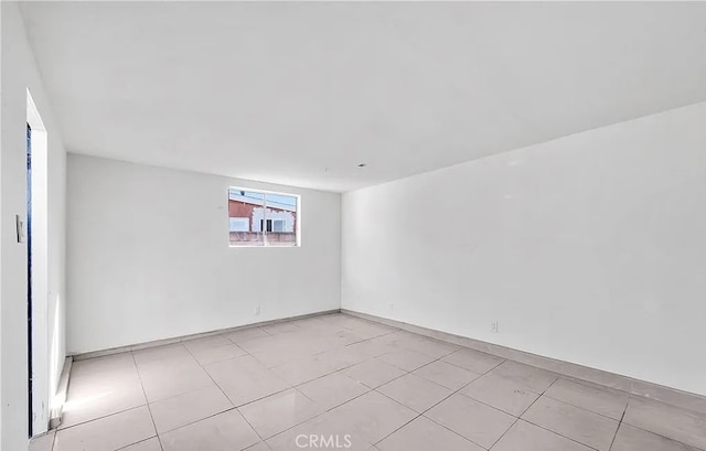 11912 Arthur Dr, Anaheim, CA 92804 - spare room with light tile patterned floors and baseboards