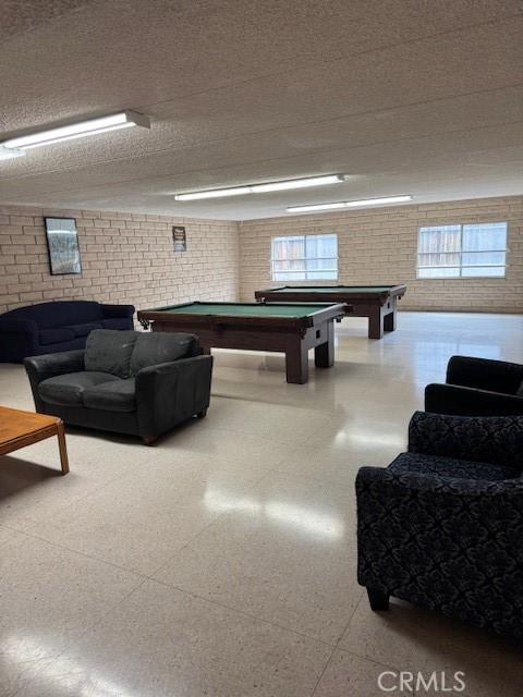 2501 W Redondo Beach Blvd Unit 317, Gardena, CA 90249 - game room with billiards, brick wall, and tile patterned floors