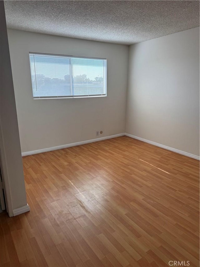 2501 W Redondo Beach Blvd Unit 317, Gardena, CA 90249 - empty room with light wood finished floors, plenty of natural light, and a textured ceiling