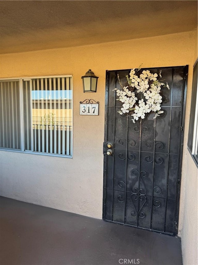 2501 W Redondo Beach Blvd Unit 317, Gardena, CA 90249 - doorway to property with stucco siding and a gate