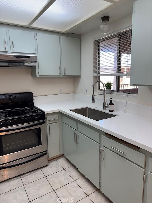 2501 W Redondo Beach Blvd Unit 317, Gardena, CA 90249 - kitchen featuring extractor fan, stainless steel gas stove, gray cabinetry, light tile patterned floors, and light countertops