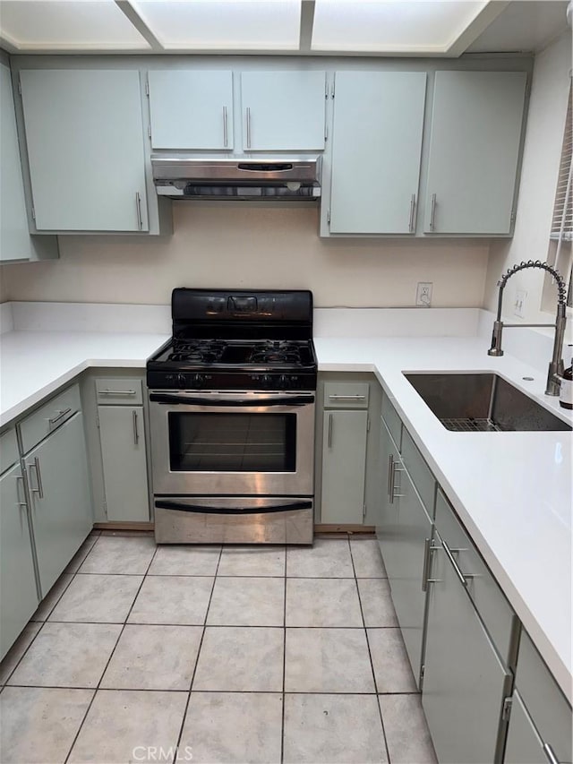 2501 W Redondo Beach Blvd Unit 317, Gardena, CA 90249 - kitchen with stainless steel gas stove, exhaust hood, gray cabinetry, and light tile patterned floors