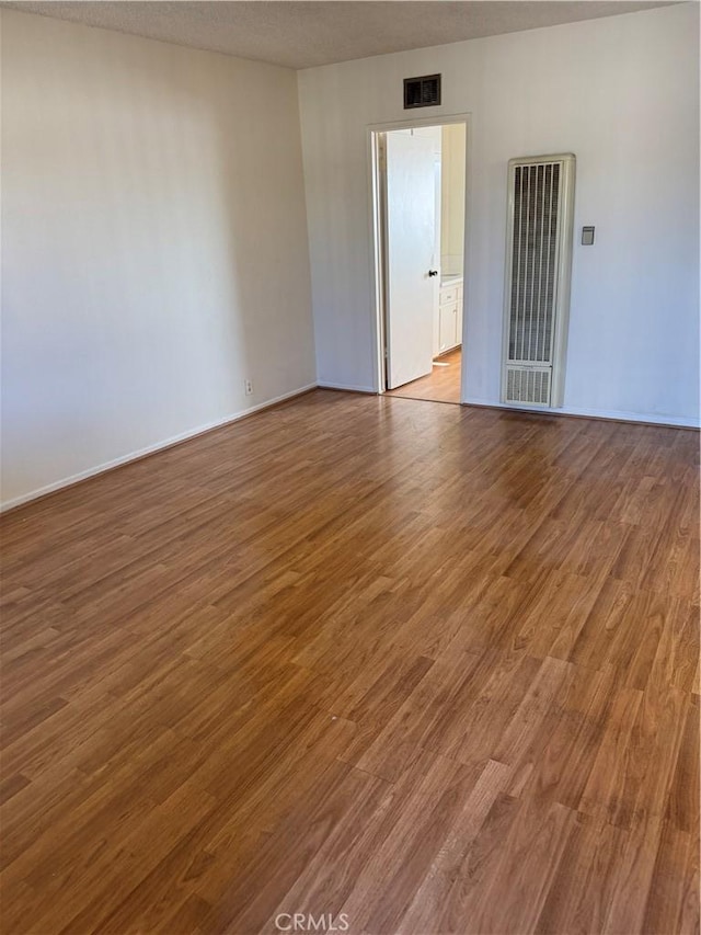 2501 W Redondo Beach Blvd Unit 317, Gardena, CA 90249 - spare room featuring a heating unit and wood finished floors