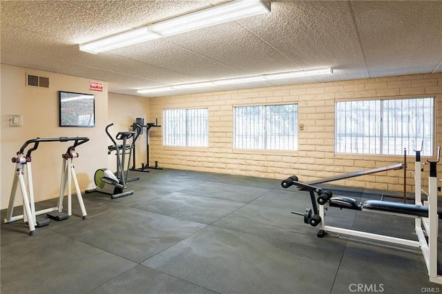 2501 W Redondo Beach Blvd Unit 317, Gardena, CA 90249 - exercise area with brick wall and a paneled ceiling
