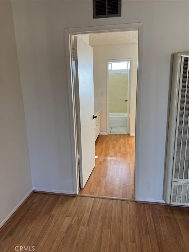 2501 W Redondo Beach Blvd Unit 317, Gardena, CA 90249 - corridor with a heating unit and light wood-type flooring