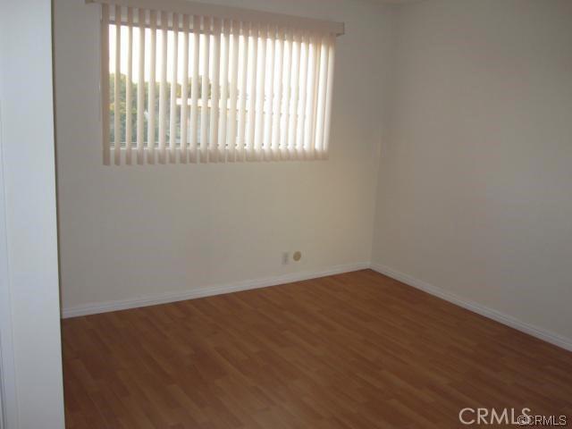 2501 W Redondo Beach Blvd Unit 317, Gardena, CA 90249 - spare room with wood finished floors and baseboards
