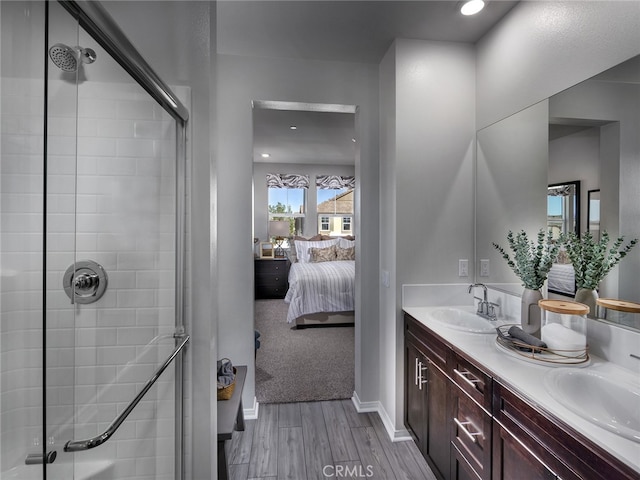 2141 Bergamot St, Redlands, CA 92374 - bathroom with wood finished floors, ensuite bath, a tile shower, double vanity, and recessed lighting