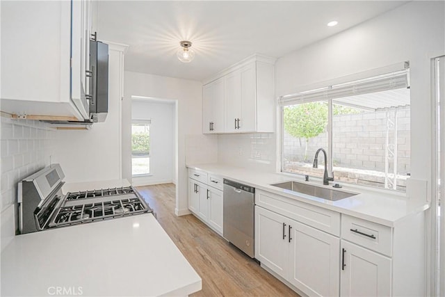 20157 Mckay Dr, Walnut, CA 91789 - kitchen featuring stainless steel appliances, decorative backsplash, light countertops, light wood-style flooring, and recessed lighting