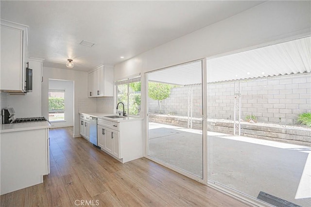 20157 Mckay Dr, Walnut, CA 91789 - kitchen featuring range, dishwasher, light wood-style flooring, light countertops, and white cabinetry