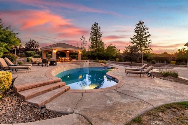 22515 Santa Clarita Corte, Perris, CA 92570 - pool at dusk featuring a gazebo, a patio area, and an outdoor pool