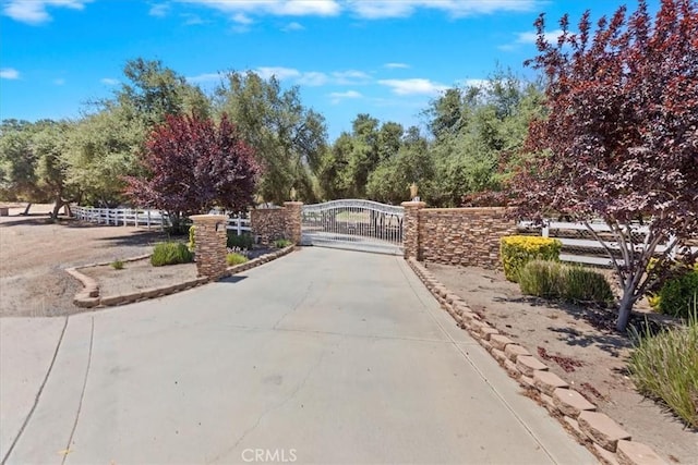 22515 Santa Clarita Corte, Perris, CA 92570 - view of concrete street with a gate, curbs, and a gated entry