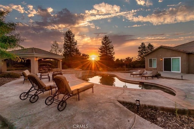 22515 Santa Clarita Corte, Perris, CA 92570 - patio terrace at dusk with a gazebo, an outdoor pool, and a patio area