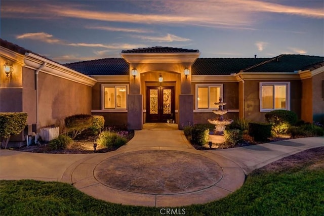 22515 Santa Clarita Corte, Perris, CA 92570 - view of exterior entry featuring french doors, a tile roof, and stucco siding