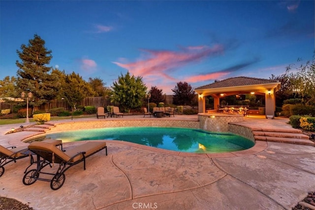 22515 Santa Clarita Corte, Perris, CA 92570 - pool at dusk featuring a gazebo, a patio, and a pool with connected hot tub