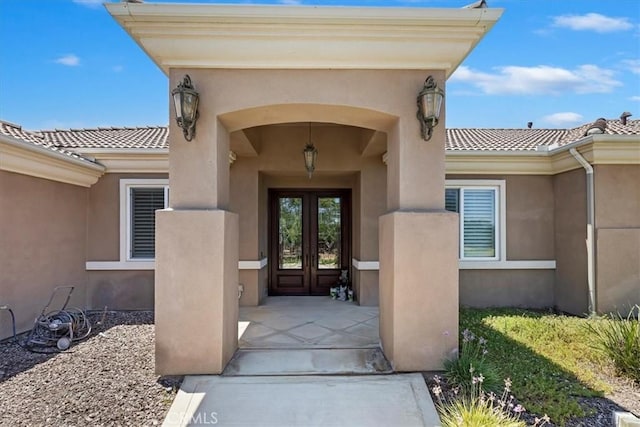22515 Santa Clarita Corte, Perris, CA 92570 - view of exterior entry with french doors, stucco siding, and a tiled roof
