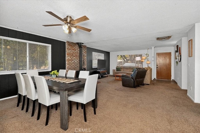 5566 Darrah Rd, Mariposa, CA 95338 - carpeted dining area with a textured ceiling, ceiling fan, and a wood stove
