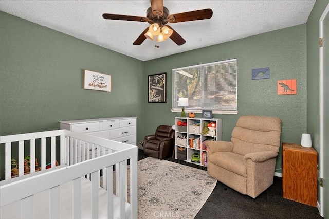 5566 Darrah Rd, Mariposa, CA 95338 - bedroom with a crib, a textured wall, carpet, a textured ceiling, and a ceiling fan