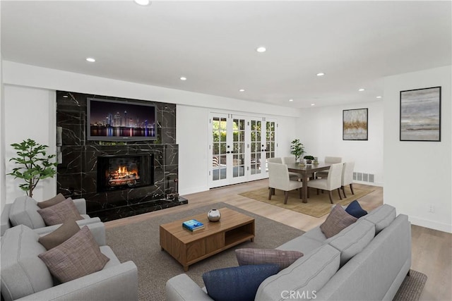 1214 Wilder St, Thousand Oaks, CA 91362 - living room featuring wood finished floors, recessed lighting, a premium fireplace, and french doors
