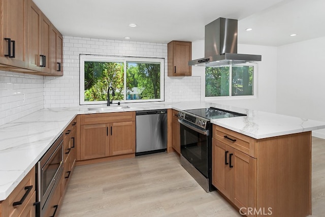 1214 Wilder St, Thousand Oaks, CA 91362 - kitchen featuring stainless steel appliances, island exhaust hood, a peninsula, light wood-style flooring, and light stone countertops
