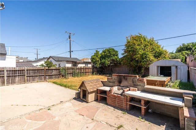 4576 166th St, Lawndale, CA 90260 - fenced backyard featuring a storage shed and a patio area