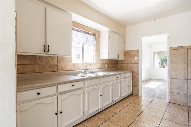 4576 166th St, Lawndale, CA 90260 - kitchen with light countertops, white cabinetry, light tile patterned floors, and backsplash