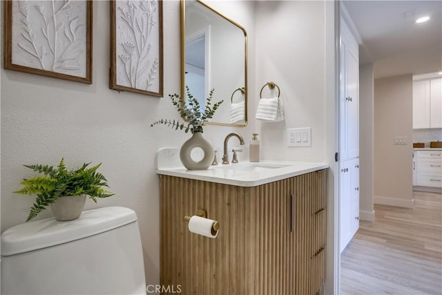 321 Orange Blossom Unit 166, Irvine, CA 92618 - half bathroom with vanity and wood finished floors