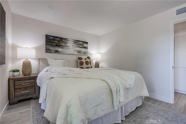 321 Orange Blossom Unit 166, Irvine, CA 92618 - bedroom featuring baseboards and light wood-style floors
