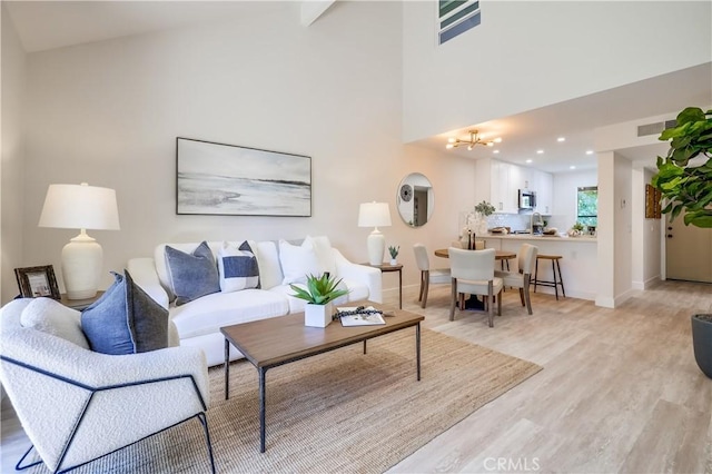 321 Orange Blossom Unit 166, Irvine, CA 92618 - living room featuring light wood finished floors, a chandelier, and high vaulted ceiling
