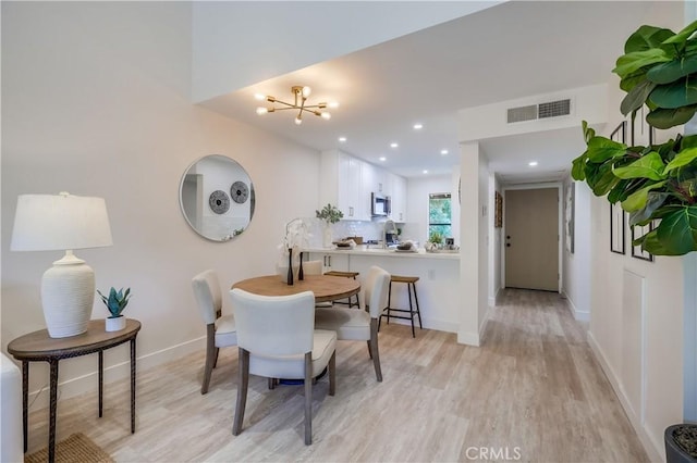 321 Orange Blossom Unit 166, Irvine, CA 92618 - dining space with light wood finished floors, a chandelier, and recessed lighting