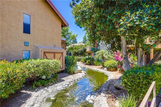 321 Orange Blossom Unit 166, Irvine, CA 92618 - view of yard with a garden pond