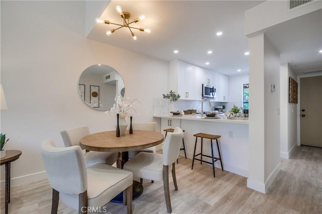 321 Orange Blossom Unit 166, Irvine, CA 92618 - dining area featuring light wood-type flooring, recessed lighting, and a chandelier