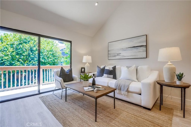 321 Orange Blossom Unit 166, Irvine, CA 92618 - living room with light wood-style floors and vaulted ceiling