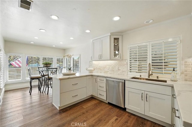 14 Bridgewood Unit 22, Irvine, CA 92604 - kitchen with stainless steel dishwasher, a peninsula, tasteful backsplash, light countertops, and recessed lighting