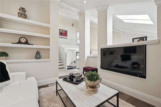 14 Bridgewood Unit 22, Irvine, CA 92604 - living area featuring stairway, decorative columns, wood finished floors, ornamental molding, and a skylight