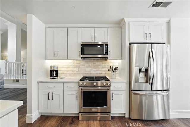 14 Bridgewood Unit 22, Irvine, CA 92604 - kitchen featuring stainless steel appliances, light countertops, tasteful backsplash, white cabinetry, and dark wood-type flooring