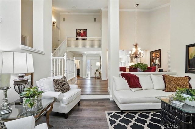 14 Bridgewood Unit 22, Irvine, CA 92604 - living area with wood finished floors, ornamental molding, a chandelier, a high ceiling, and stairs