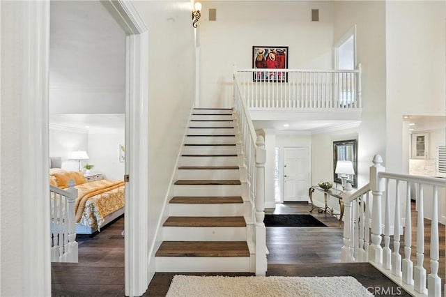 14 Bridgewood Unit 22, Irvine, CA 92604 - staircase featuring wood finished floors, ornamental molding, and a high ceiling