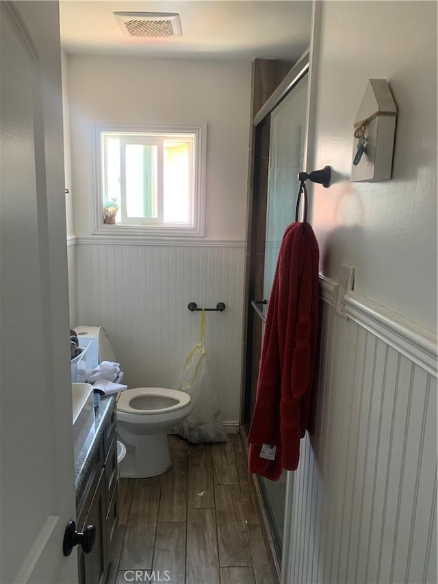 22315 Ibex Ave, Hawaiian Gardens, CA 90716 - full bathroom with a wainscoted wall, vanity, wood finished floors, and a stall shower