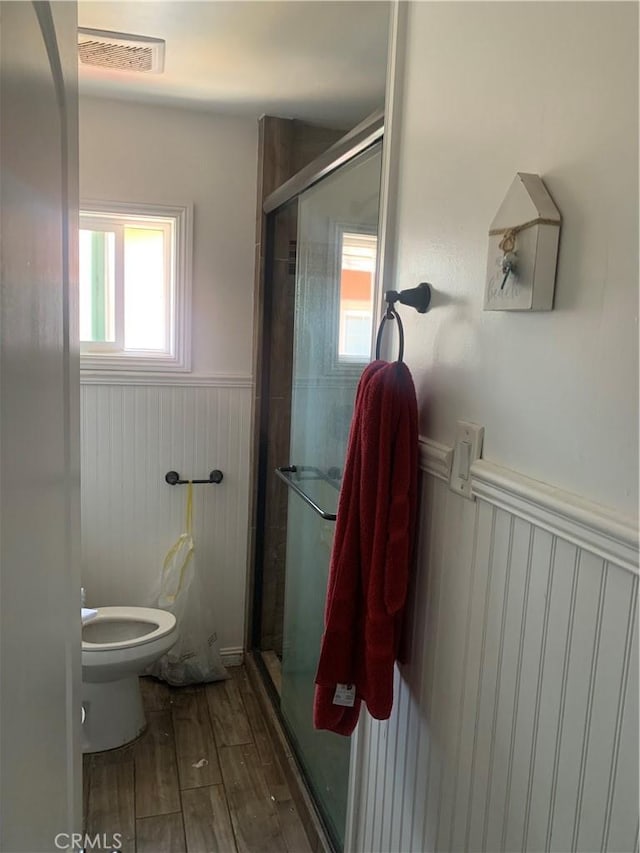 22315 Ibex Ave, Hawaiian Gardens, CA 90716 - bathroom featuring a wainscoted wall, wood finished floors, and a stall shower