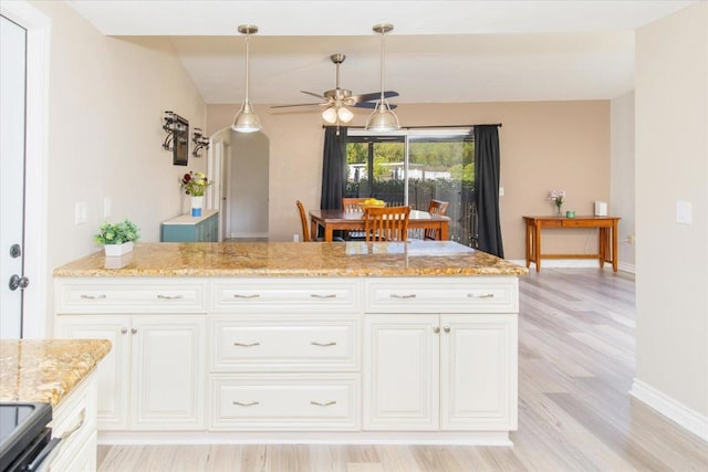 24093 Sargeant Rd, Ramona, CA 92065 - kitchen with a ceiling fan, light wood-style floors, light stone countertops, stainless steel electric range, and white cabinets