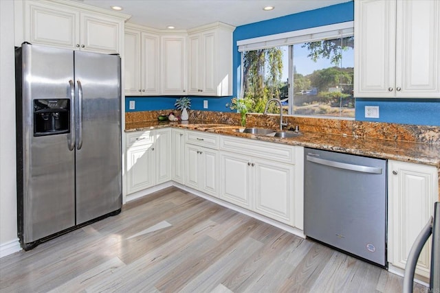 24093 Sargeant Rd, Ramona, CA 92065 - kitchen with stainless steel appliances, dark stone counters, light wood-type flooring, recessed lighting, and white cabinetry