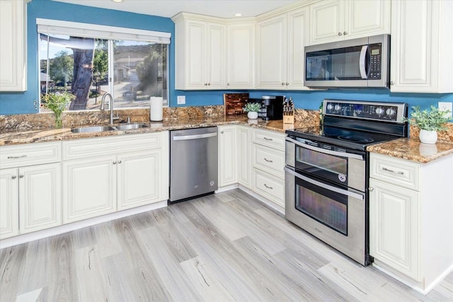 24093 Sargeant Rd, Ramona, CA 92065 - kitchen with stainless steel appliances, light stone countertops, light wood finished floors, recessed lighting, and white cabinets