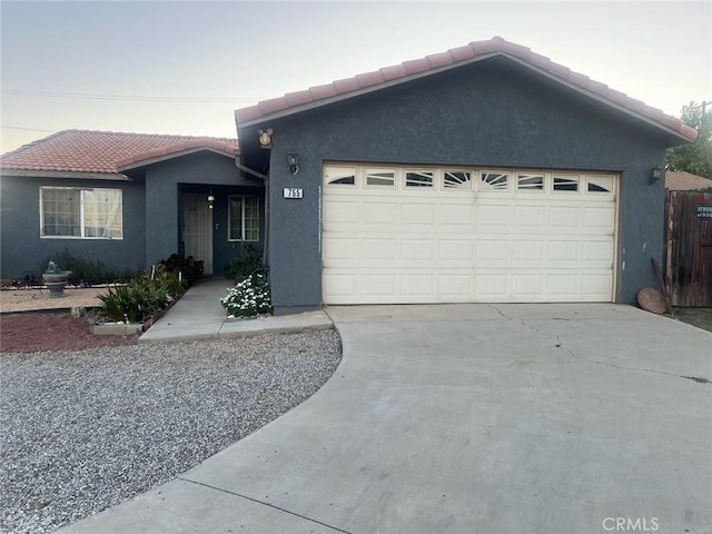 755 N Allen St, Banning, CA 92220 - single story home featuring a tiled roof, an attached garage, stucco siding, and driveway