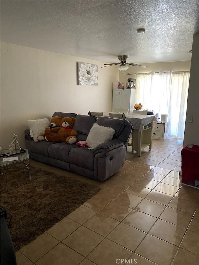 755 N Allen St, Banning, CA 92220 - living room with light tile patterned floors, a textured ceiling, and a ceiling fan