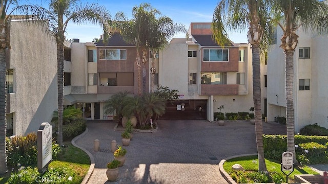 5325 Newcastle Ave Unit 319, Encino, CA 91316 - view of building exterior with decorative driveway and a garage