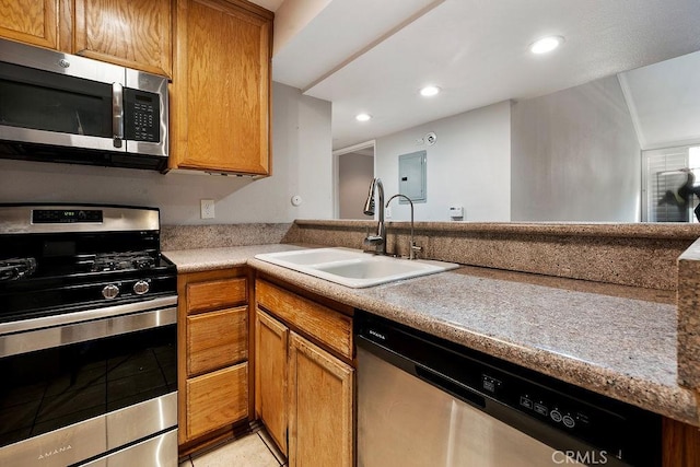 5325 Newcastle Ave Unit 319, Encino, CA 91316 - kitchen featuring stainless steel appliances, electric panel, light tile patterned flooring, recessed lighting, and brown cabinetry