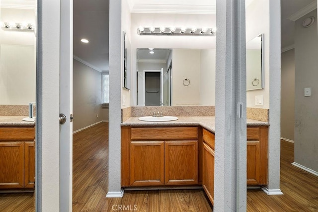 5325 Newcastle Ave Unit 319, Encino, CA 91316 - bathroom featuring crown molding, vanity, and wood finished floors