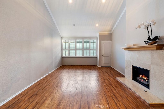 5325 Newcastle Ave Unit 319, Encino, CA 91316 - unfurnished living room featuring crown molding, a tiled fireplace, and wood finished floors